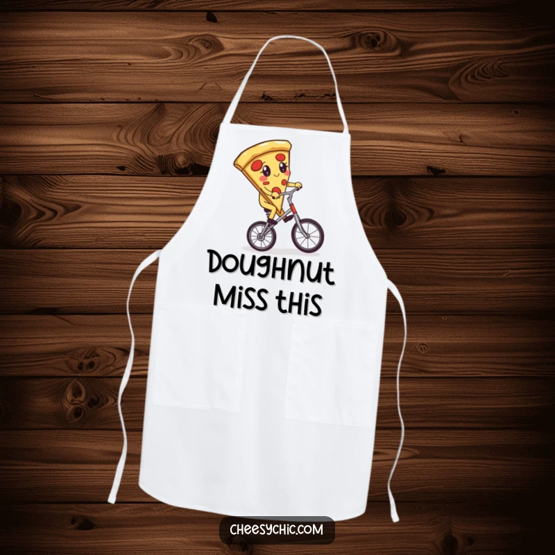 Funny apron depicting an adorable anthropomorphic pizza slice attempting to ride a unicycle, a comical kitchen essential for food lovers.