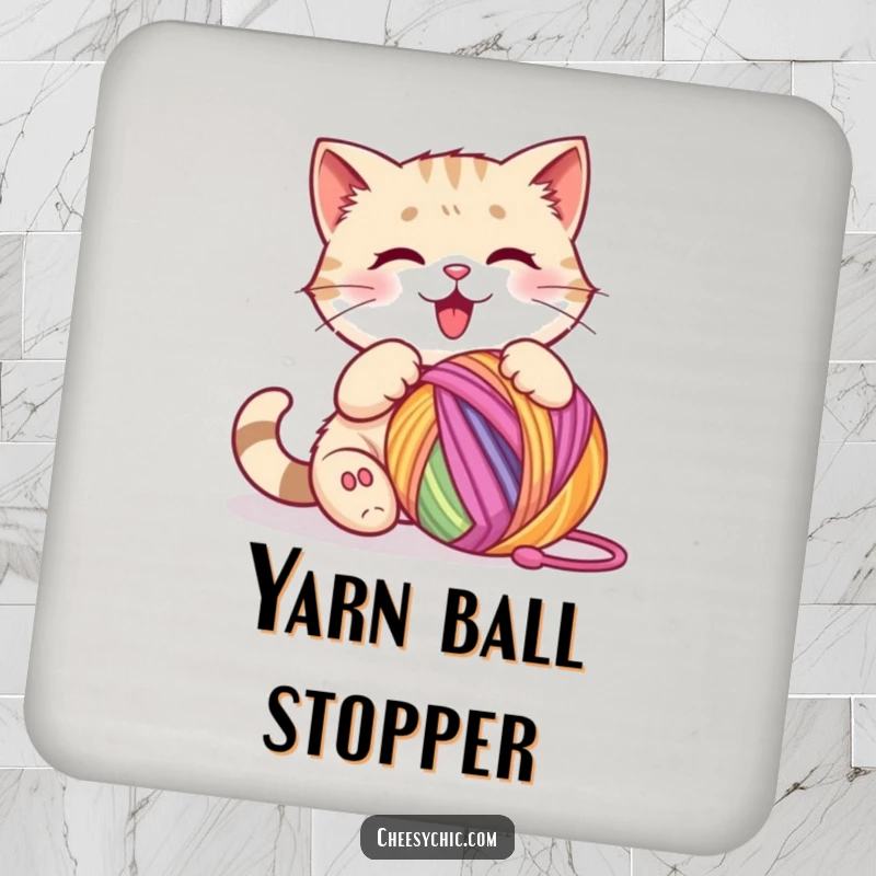 Funny coaster featuring a cute cat character happily batting at a colorful ball of yarn.