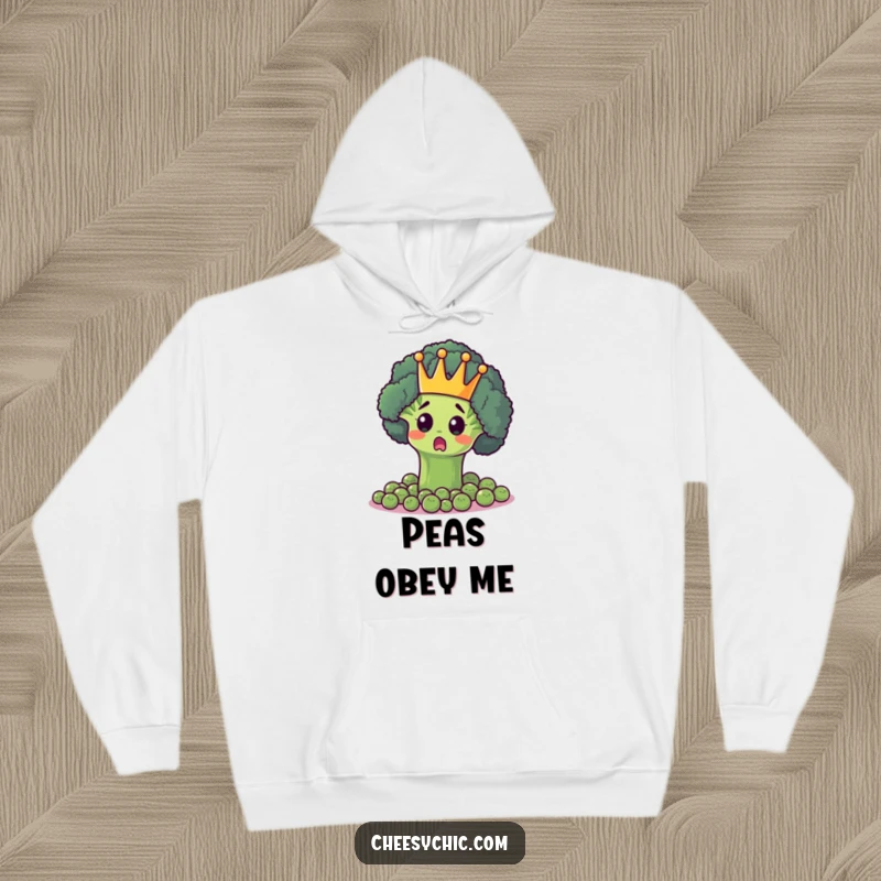 Funny hoodie with a surprised broccoli floret wearing a crown, presiding over a kingdom of peas, exuding green authority.