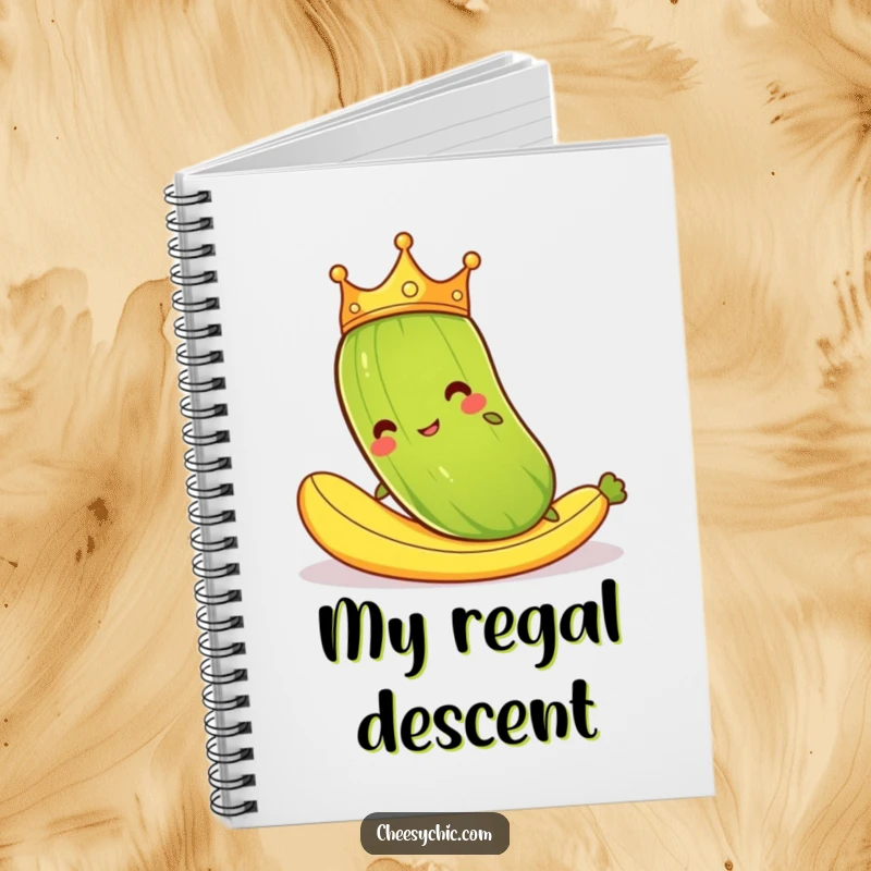 Funny notebook with a cartoon pickle wearing a crown, comically slipping on a banana peel, perfect for journaling with humor.