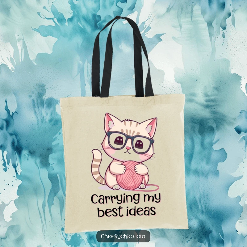 Funny tote bag featuring a cute cat with reading glasses, thoughtfully examining a yarn ball, stylish and humorous accessory.