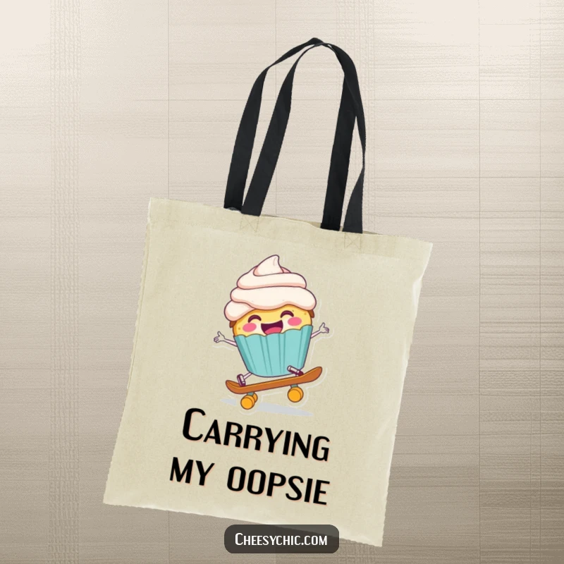 Funny tote bag showing a happy anthropomorphic cupcake comically falling off a tiny skateboard, mid-tumble with a cheerful face.
